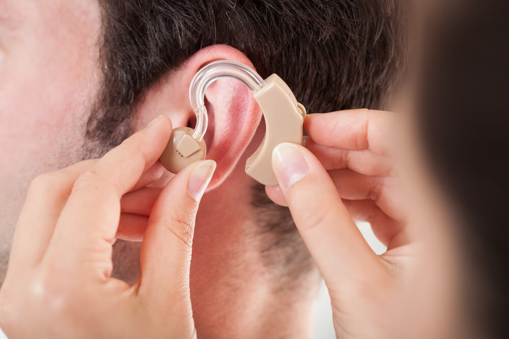 putting on hearing aid